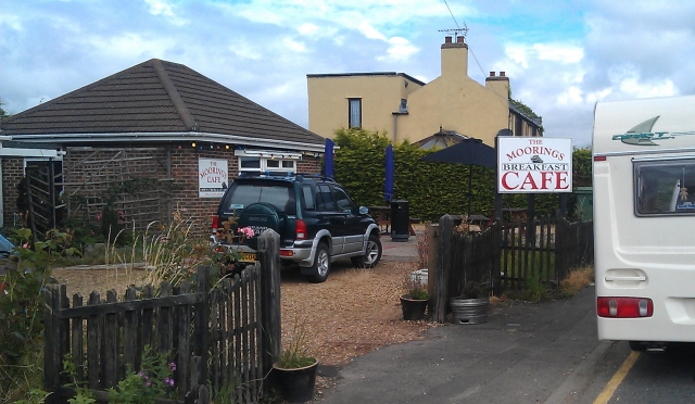 The Moorings Cafe Boston/Fosdyke. A small single story brick building with signs for the cafe